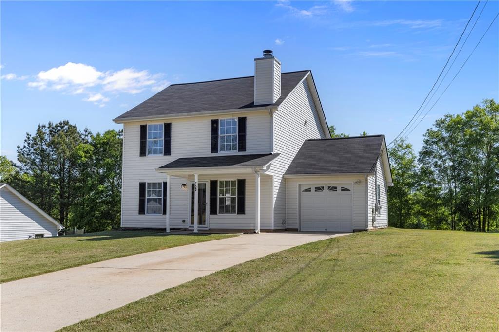 150 Fairclift Drive Covington, GA 30016 - Photo 2 of 22 a front view of a house with a garden