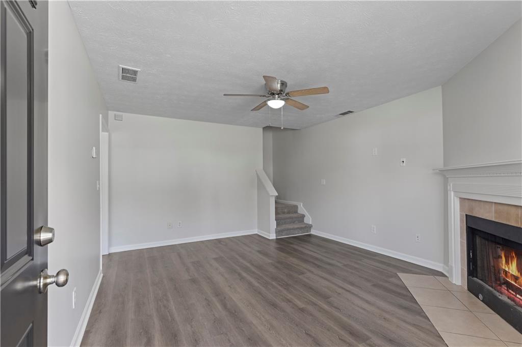 150 Fairclift Drive Covington, GA 30016 - Photo 4 of 22 wooden floor in an empty room with a fireplace