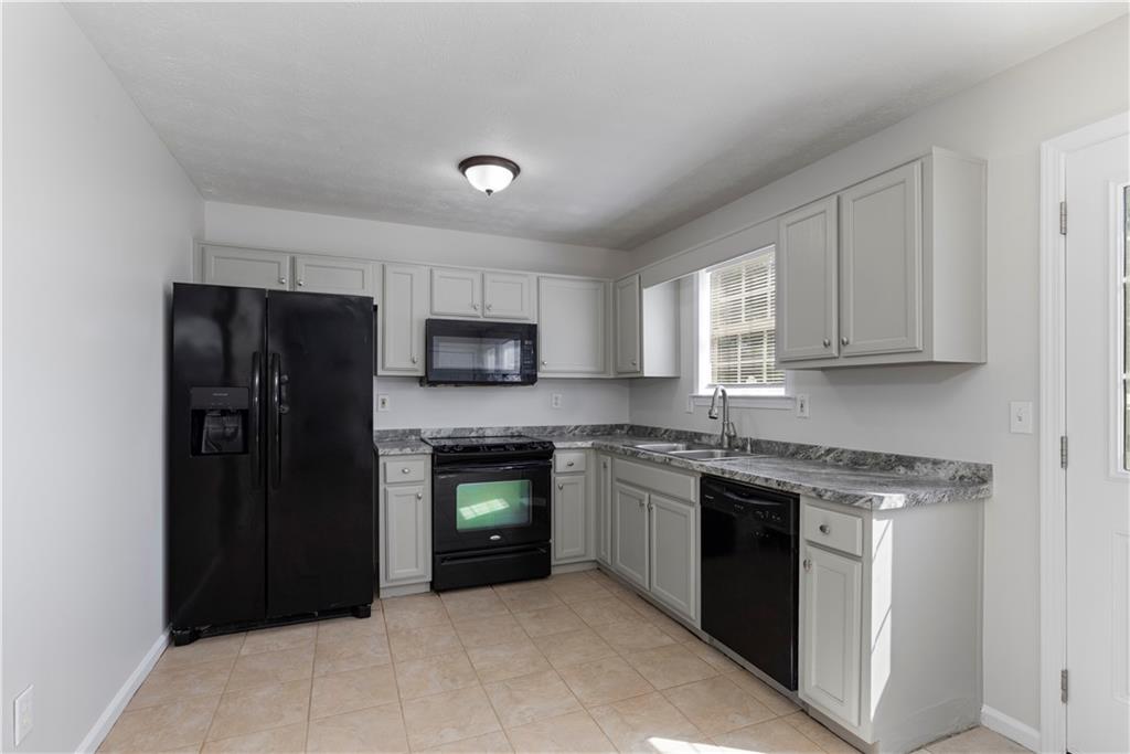 150 Fairclift Drive Covington, GA 30016 - Photo 5 of 22 a kitchen with stainless steel appliances granite countertop a refrigerator and a stove top oven