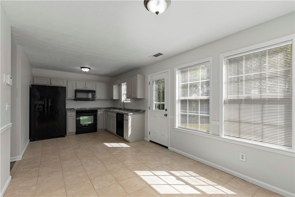 150 Fairclift Drive Covington, GA 30016 - Photo 7 of 22 a view of a kitchen with refrigerator and windows