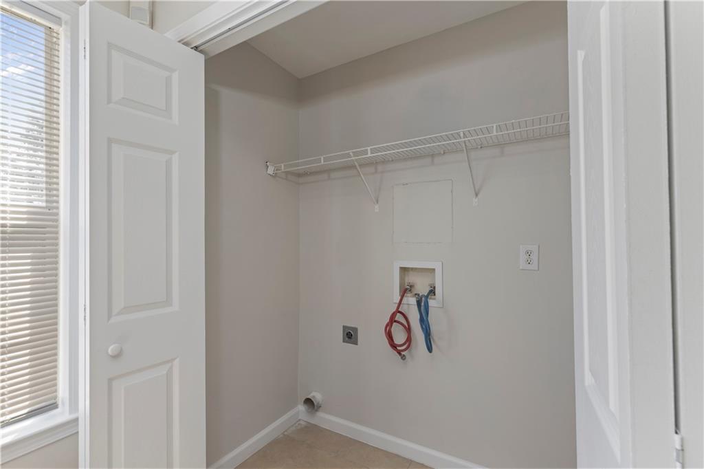 150 Fairclift Drive Covington, GA 30016 - Photo 9 of 22 a view of storage and utility room with racks on the wall
