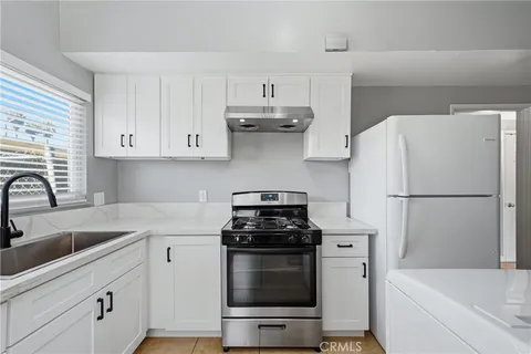 a kitchen with a refrigerator and a sink