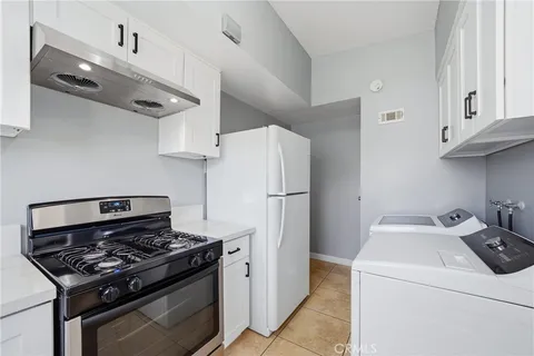 a kitchen with a stove and a refrigerator