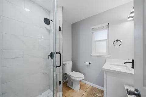 a bathroom with a toilet and a shower
