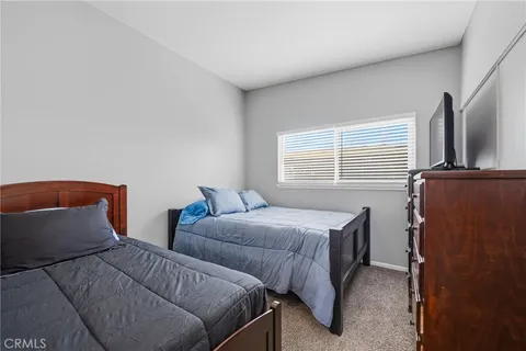 a bedroom with two beds and a window