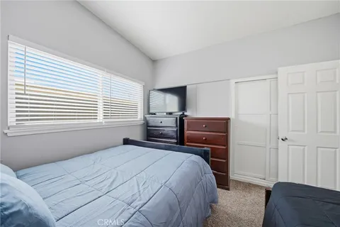 a bedroom with a bed and a television