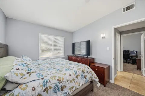 a bedroom with a bed and a television in it