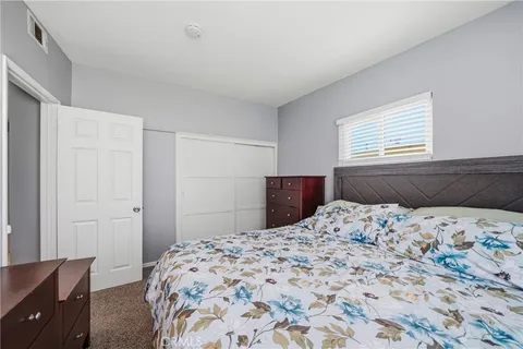 a bedroom with a bed and a dresser