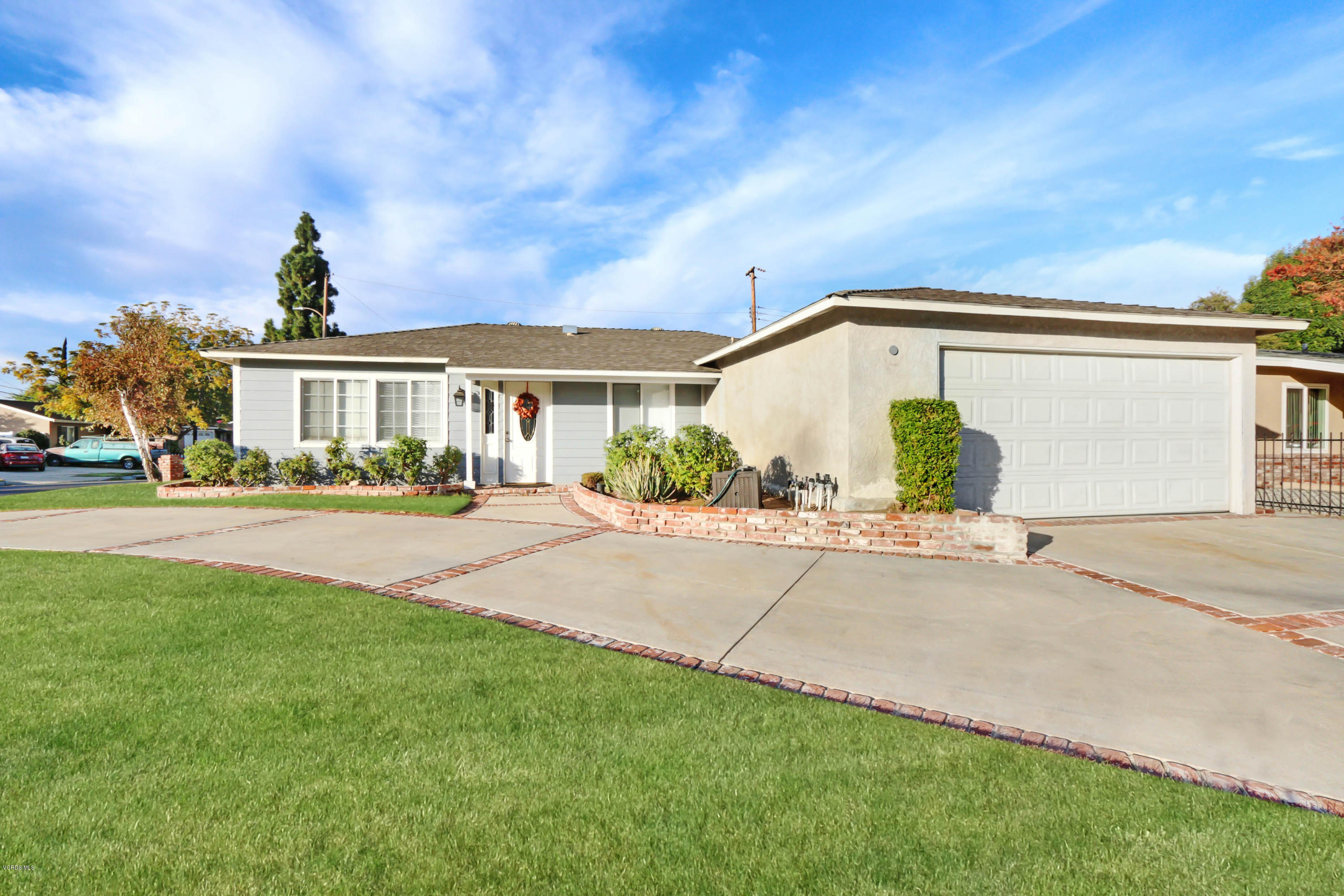 6205 Melia Street Simi Valley, CA 93063 - Photo 2 of 36 a front view of a house with a yard and outdoor seating