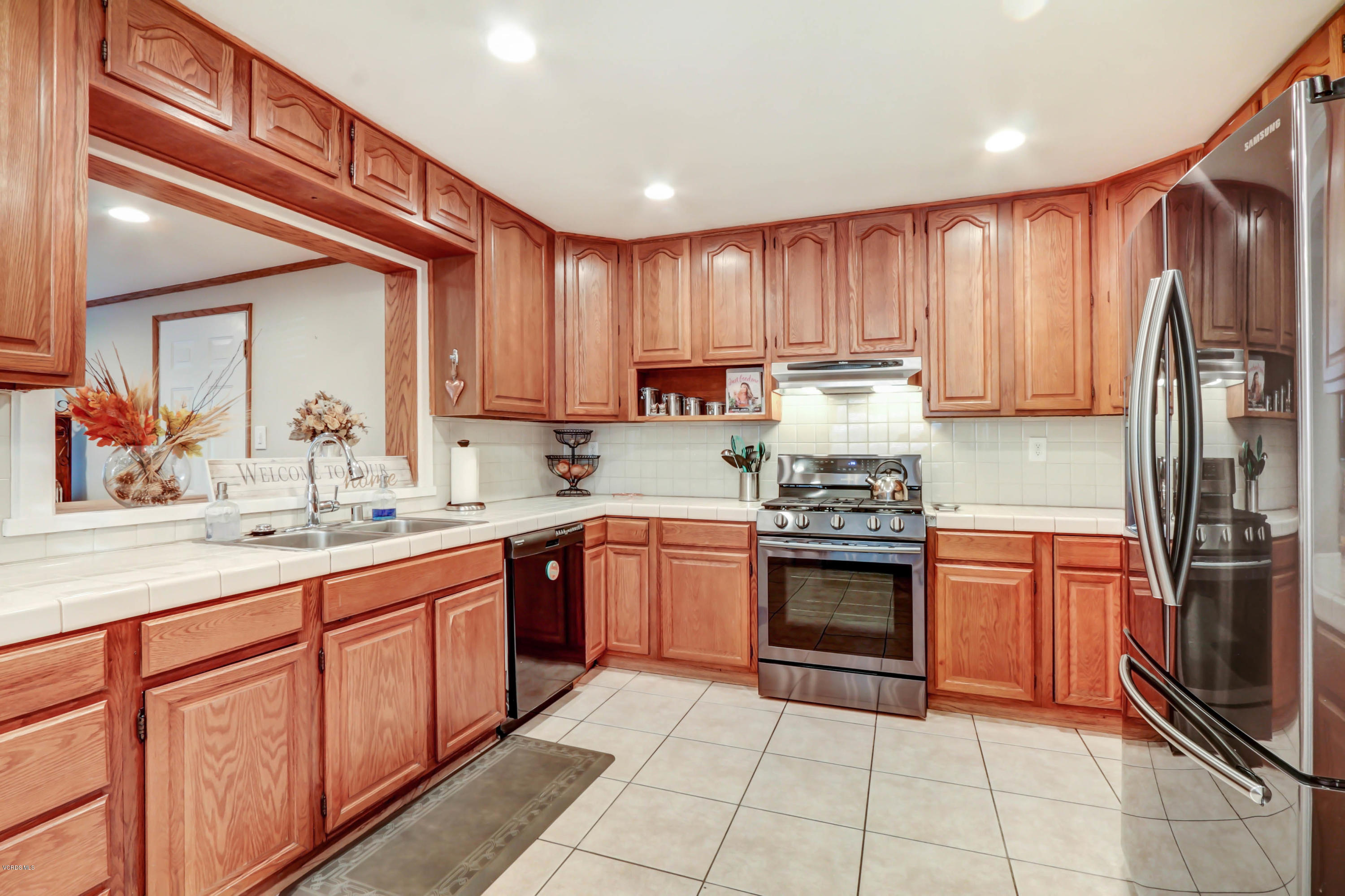 6205 Melia Street Simi Valley, CA 93063 - Photo 11 of 36 a kitchen with stainless steel appliances granite countertop a refrigerator and a stove top oven