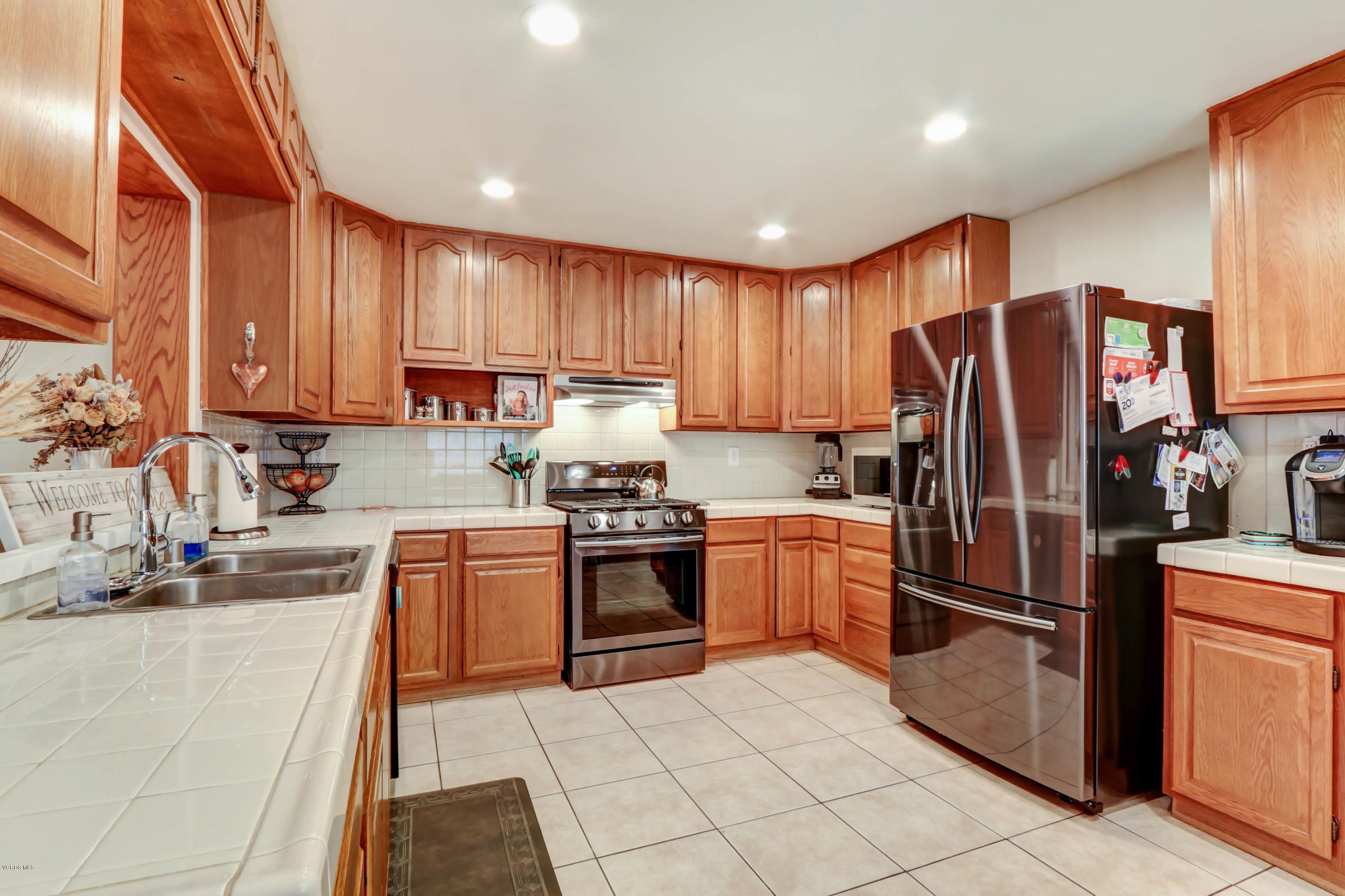 6205 Melia Street Simi Valley, CA 93063 - Photo 12 of 36 a kitchen with granite countertop stainless steel appliances and cabinets