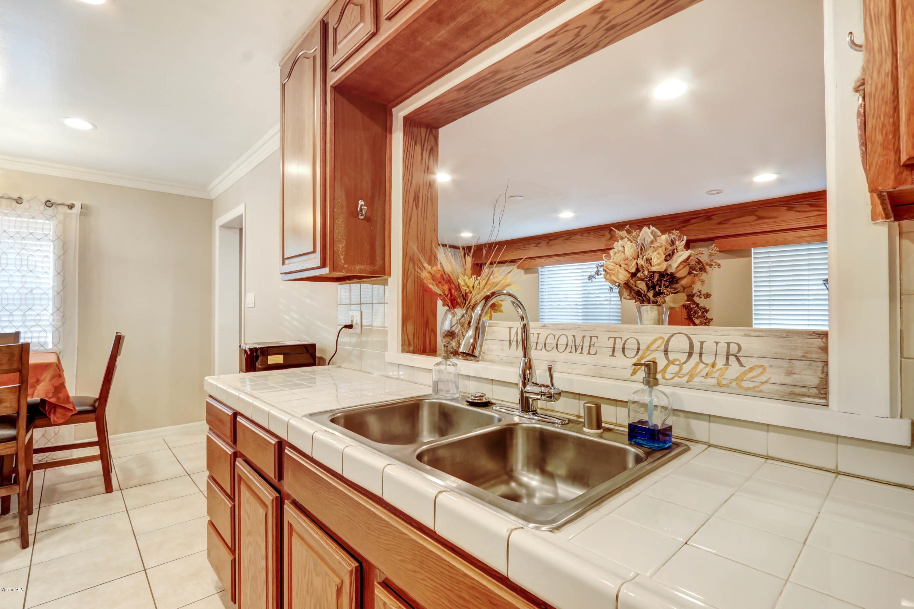 6205 Melia Street Simi Valley, CA 93063 - Photo 15 of 36 a kitchen that has a sink and a large window