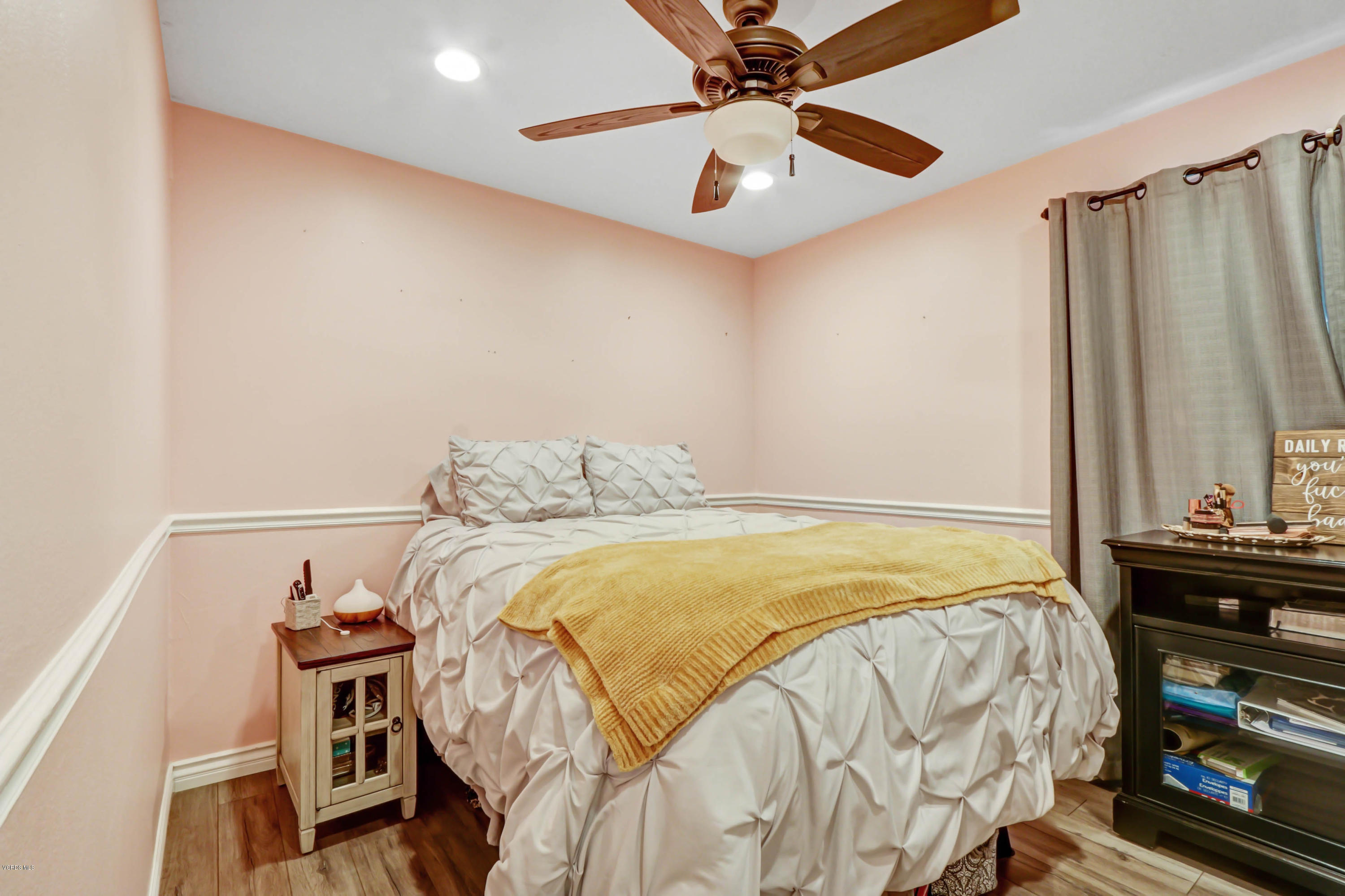 6205 Melia Street Simi Valley, CA 93063 - Photo 20 of 36 a bedroom with a bed and a chandelier