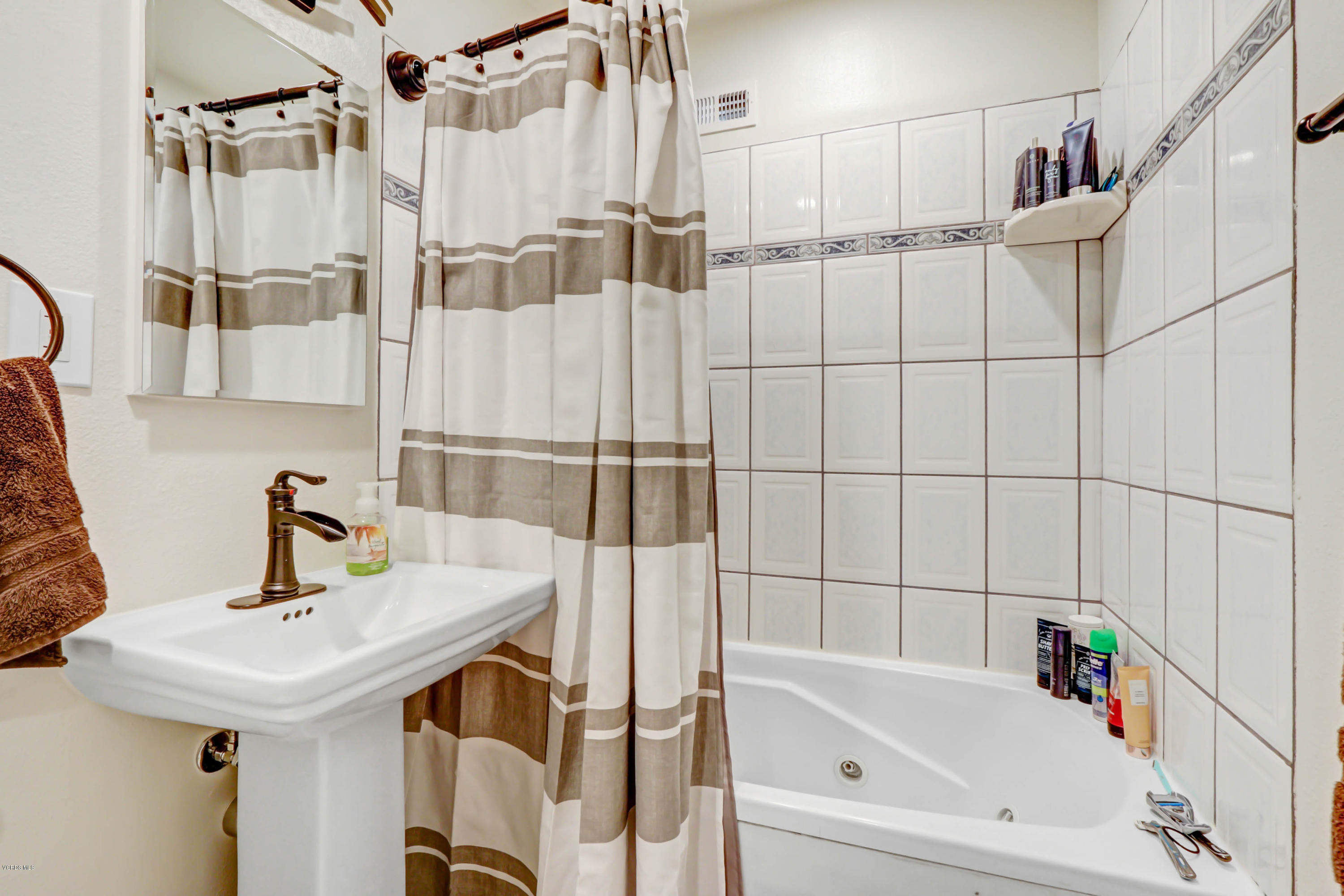 6205 Melia Street Simi Valley, CA 93063 - Photo 21 of 36 a bathroom with a bathtub and a sink