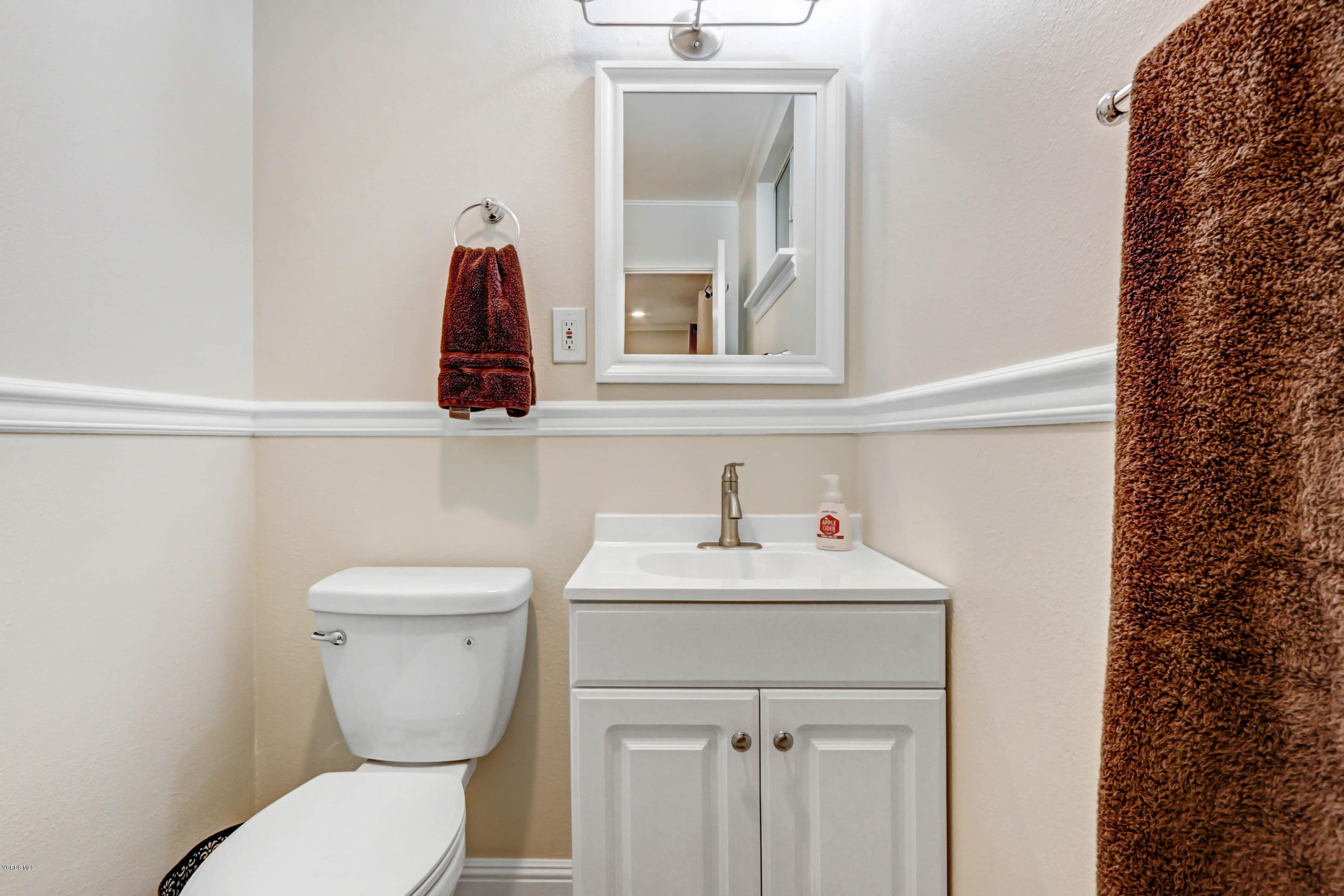 6205 Melia Street Simi Valley, CA 93063 - Photo 25 of 36 a bathroom with a toilet sink and mirror