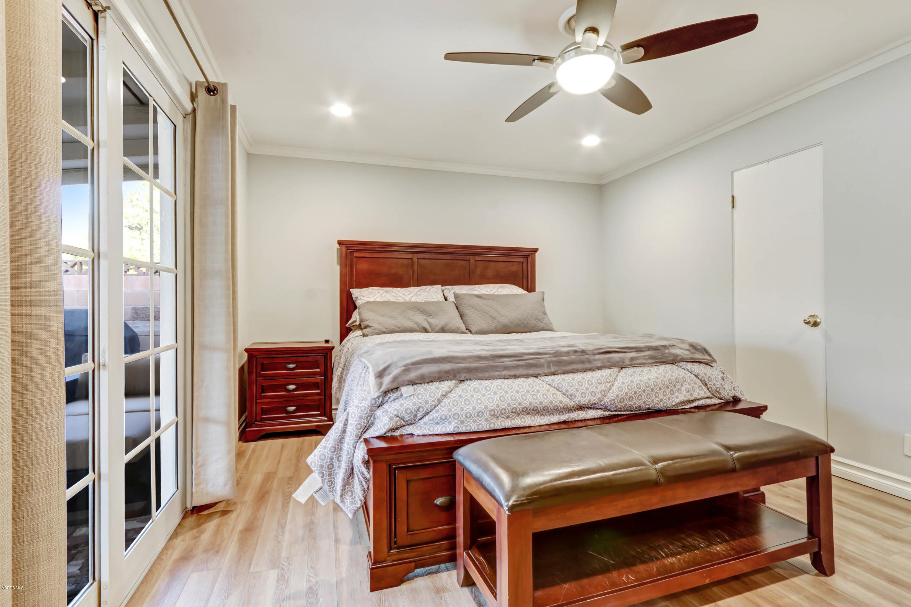 6205 Melia Street Simi Valley, CA 93063 - Photo 27 of 36 a bedroom with a bed and a chandelier