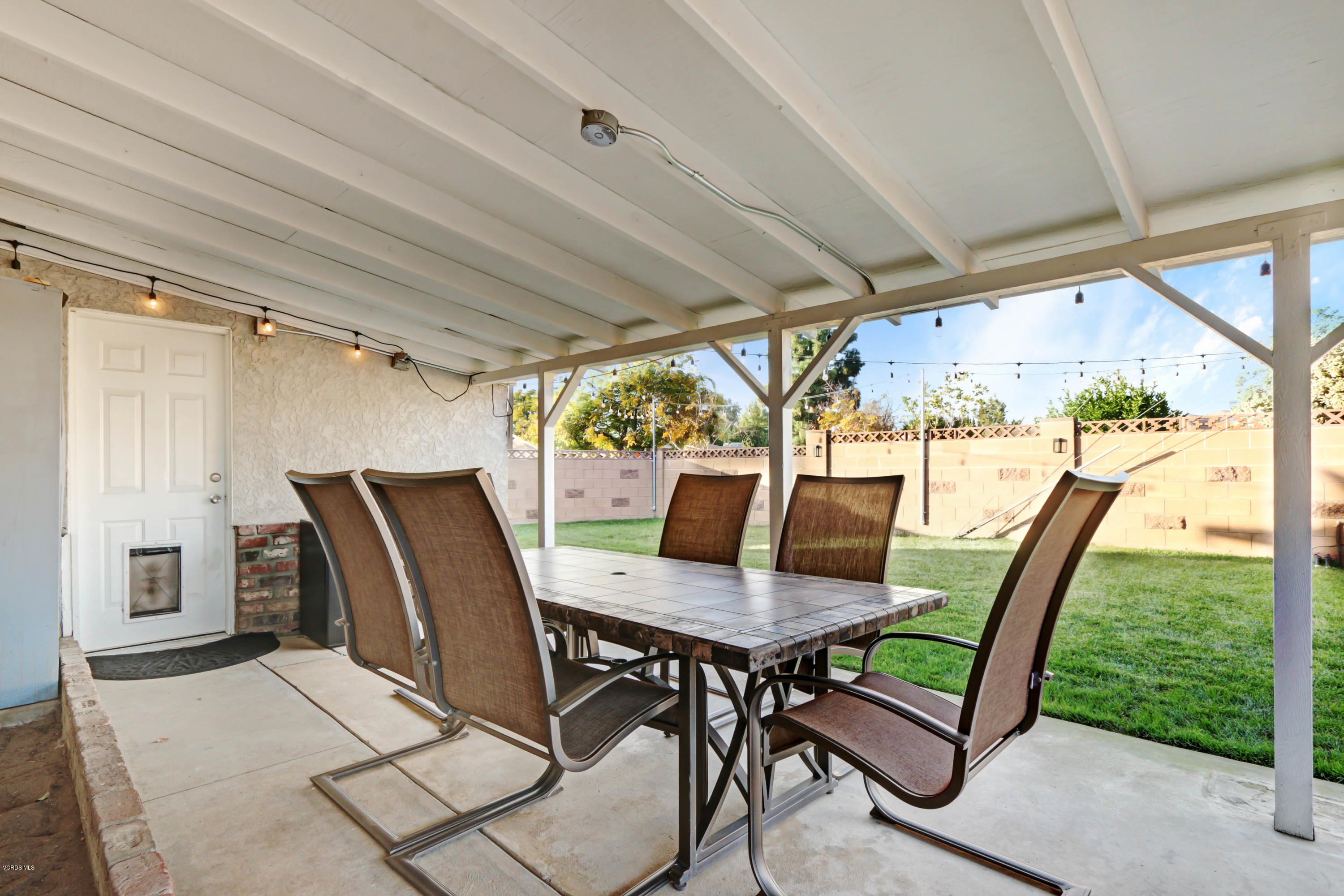 6205 Melia Street Simi Valley, CA 93063 - Photo 30 of 36 a view of a porch with furniture and a yard