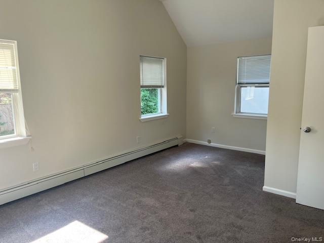 92 Harbor Road Port Washington, NY 11050 - Photo 7 of 15 Largest Bedroom with a baseboard radiator, lofted ceiling, carpet, and plenty of natural light