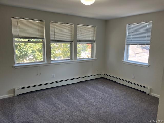 92 Harbor Road Port Washington, NY 11050 - Photo 8 of 15 Spare room with carpet and a baseboard heating unit