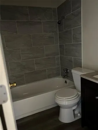 a bathroom with a toilet and a bathtub