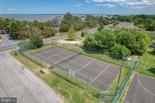 a view of a backyard with wooden fence