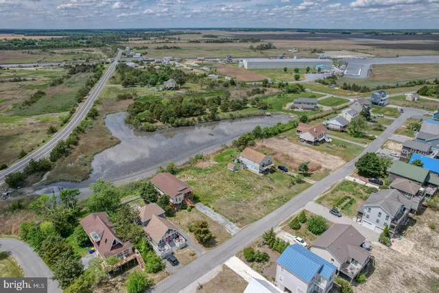 a aerial view of a house with a yard and lake view