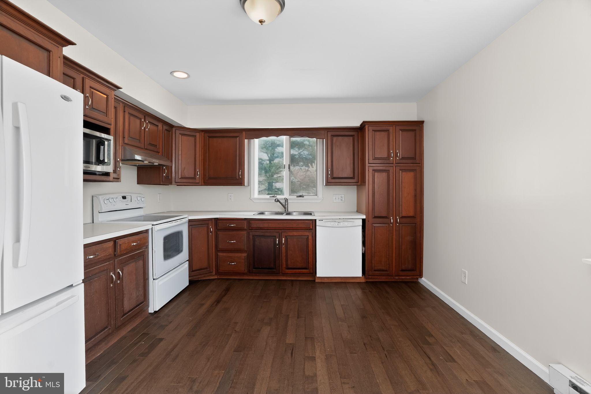 540 Martins Corner Road Coatesville, PA 19320 - Photo 10 of 33 Modern kitchen with rich wood cabinetry.
