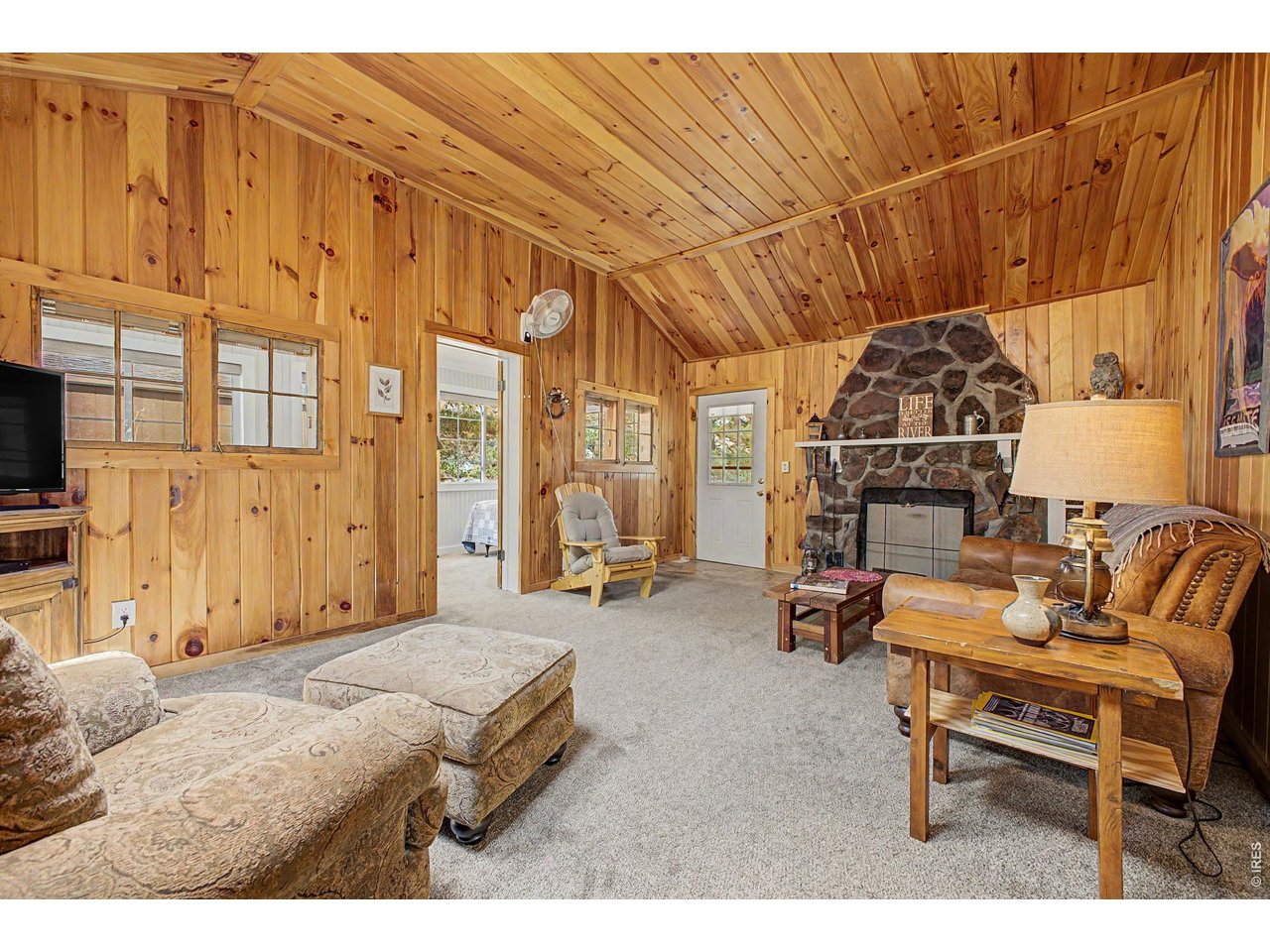 259 Riverside Drive Lyons, CO 80540 - Photo 7 of 50 Main cabin great room with fireplace.