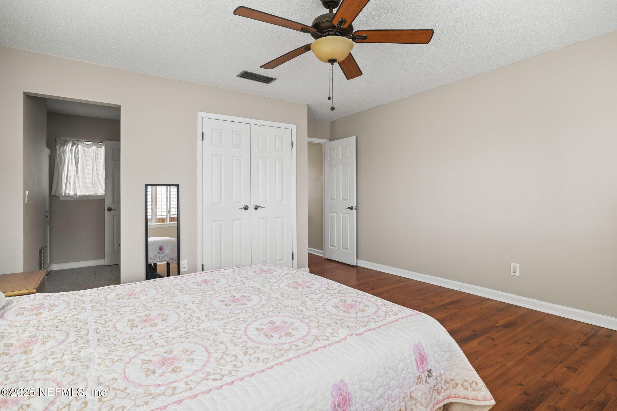 1107 1st Street South, Unit B Jacksonville Beach, FL 32250 - Photo 16 of 45 a bedroom with a bed and a chandelier