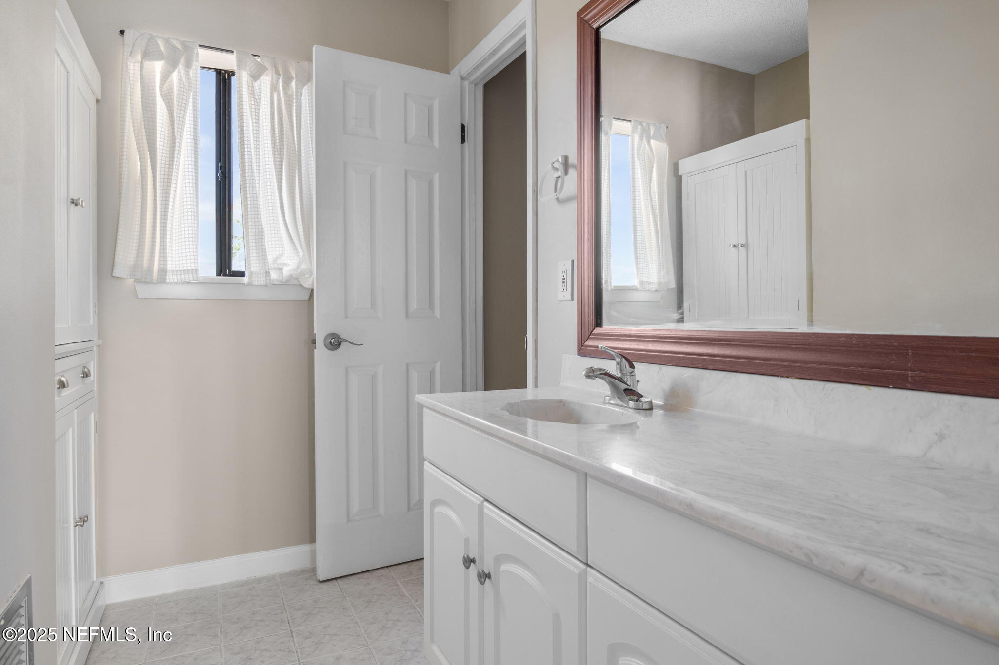 1107 1st Street South, Unit B Jacksonville Beach, FL 32250 - Photo 17 of 45 a bathroom with a sink and a mirror