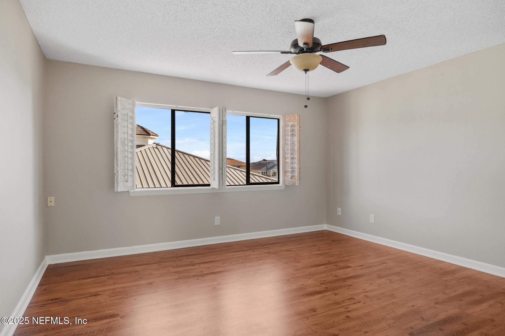 1107 1st Street South, Unit B Jacksonville Beach, FL 32250 - Photo 34 of 45 a view of empty room with wooden floor and fan