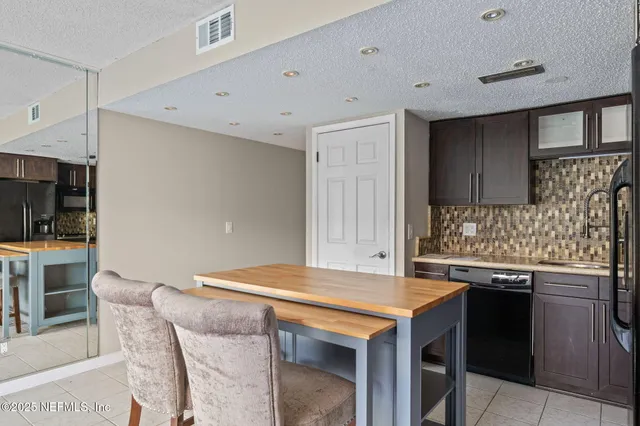 a kitchen with stainless steel appliances granite countertop a sink and a stove