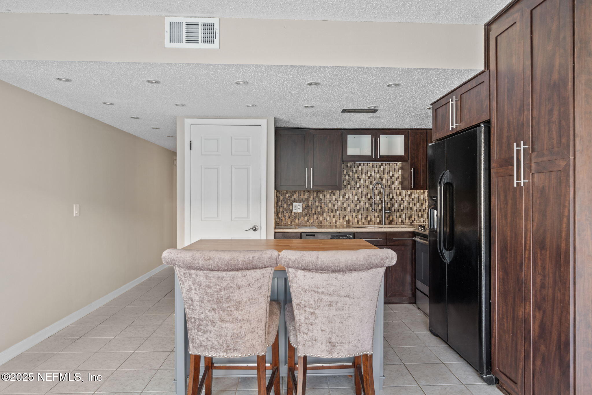 1107 1st Street South, Unit B Jacksonville Beach, FL 32250 - Photo 5 of 45 a kitchen with granite countertop cabinets and refrigerator