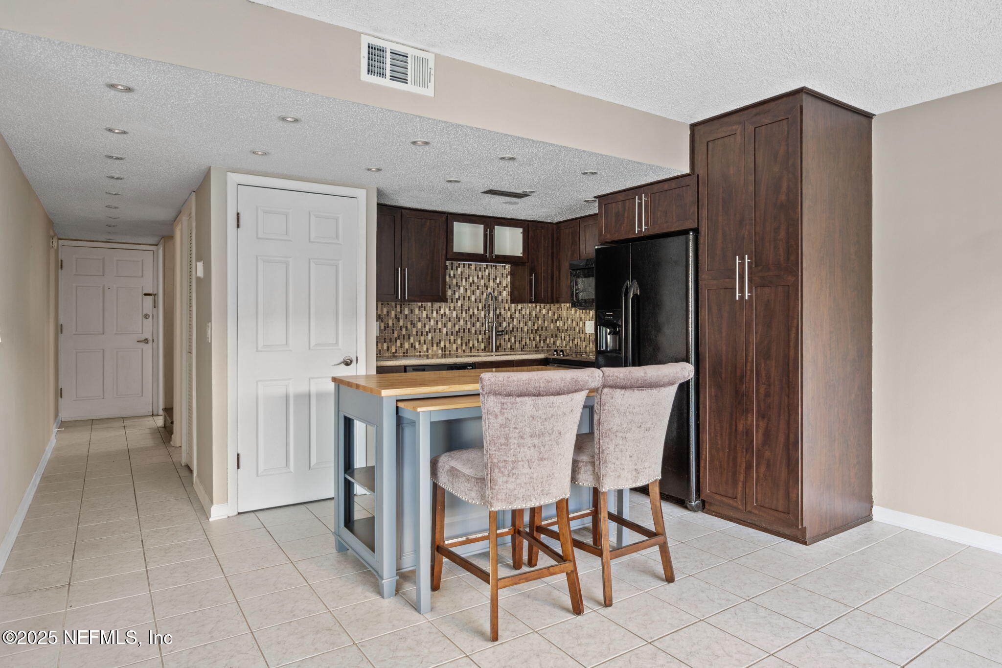 1107 1st Street South, Unit B Jacksonville Beach, FL 32250 - Photo 6 of 45 a kitchen with stainless steel appliances granite countertop a refrigerator and a sink