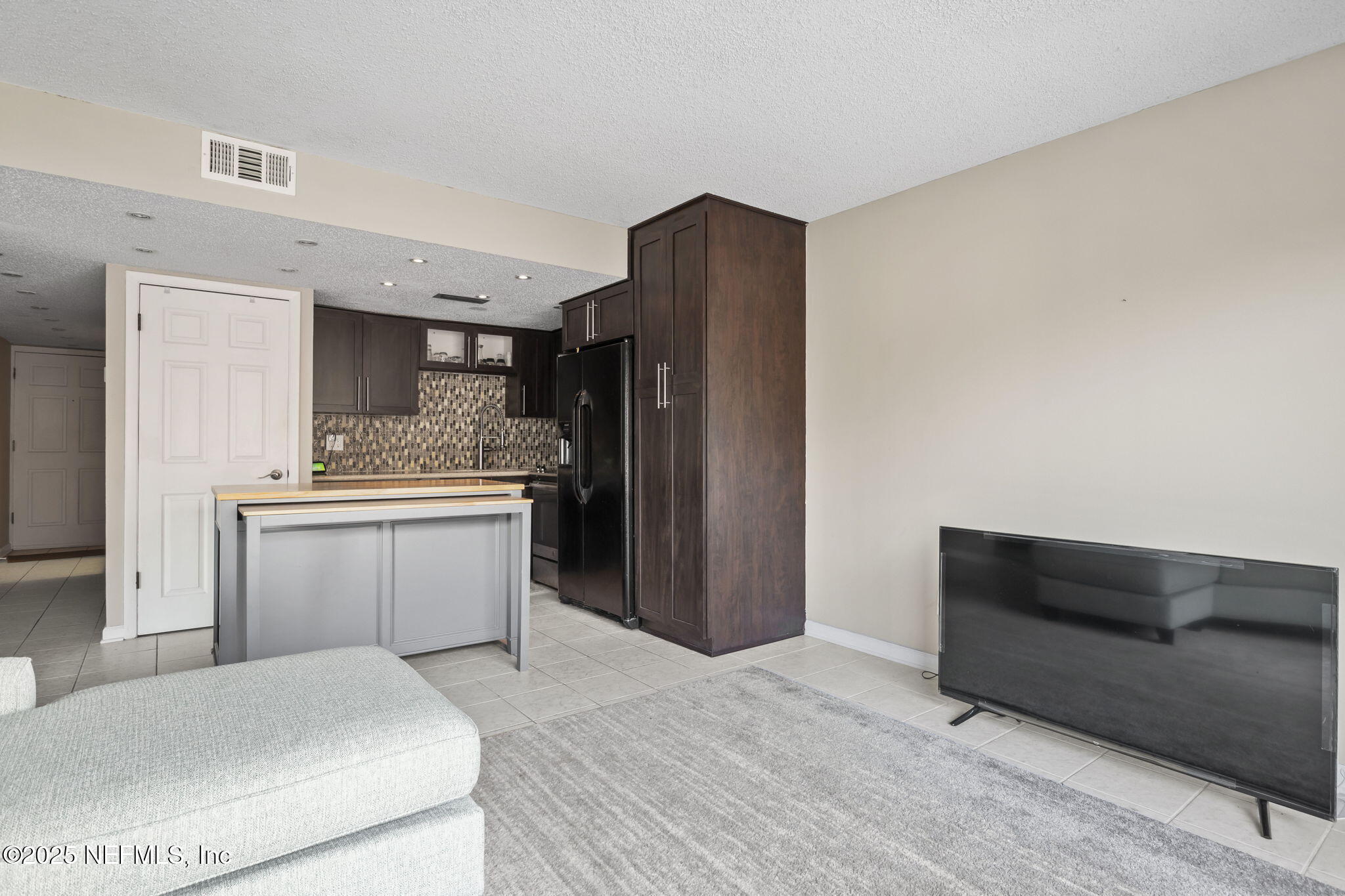 1107 1st Street South, Unit B Jacksonville Beach, FL 32250 - Photo 10 of 45 a kitchen with a refrigerator and cabinets