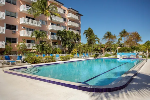 a view of swimming pool with outdoor seating and plants
