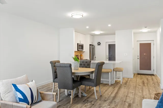 a dining room with furniture and wooden floor