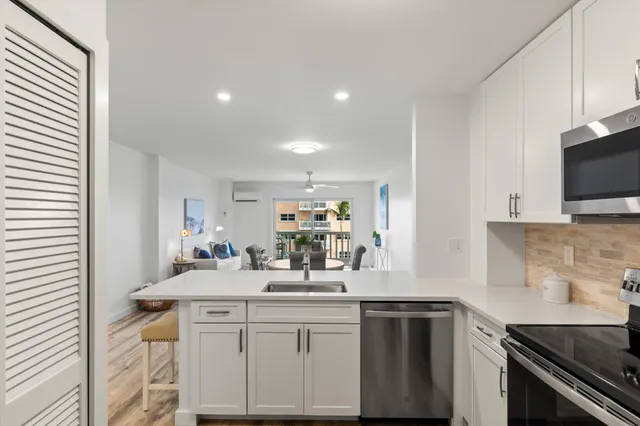 a kitchen with sink stove and microwave