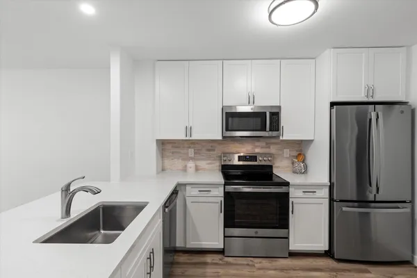 a kitchen with a sink stove and refrigerator