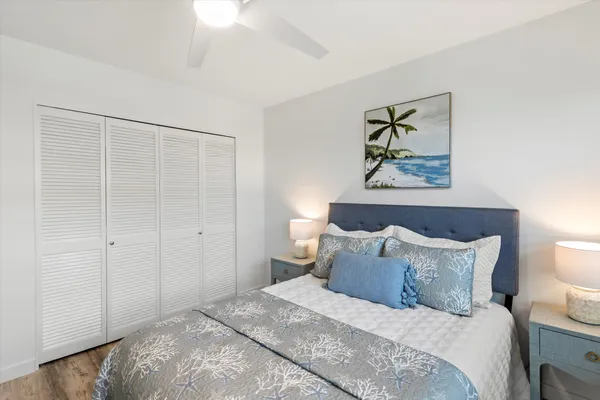 a bedroom with a bed and a painting on the wall