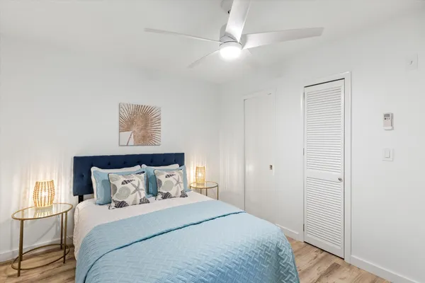 a bedroom with a bed and a chandelier