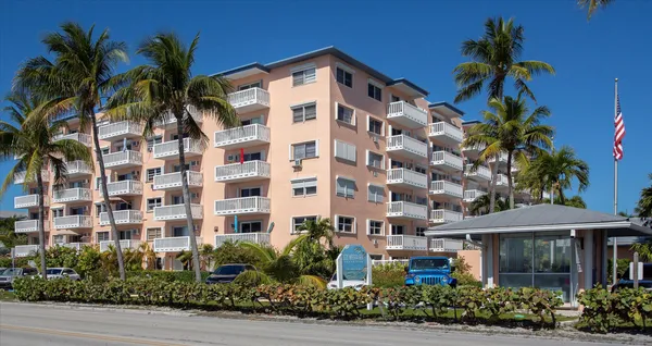 a front view of a multi story building with yard