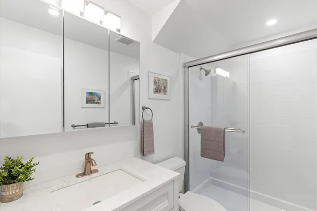 a bathroom with a sink toilet and shower