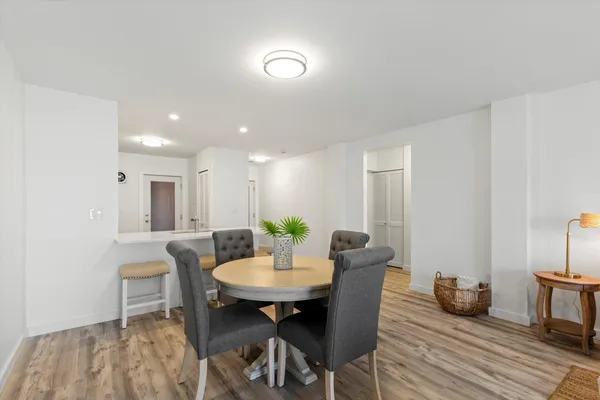 a view of a dining room with furniture and wooden floor