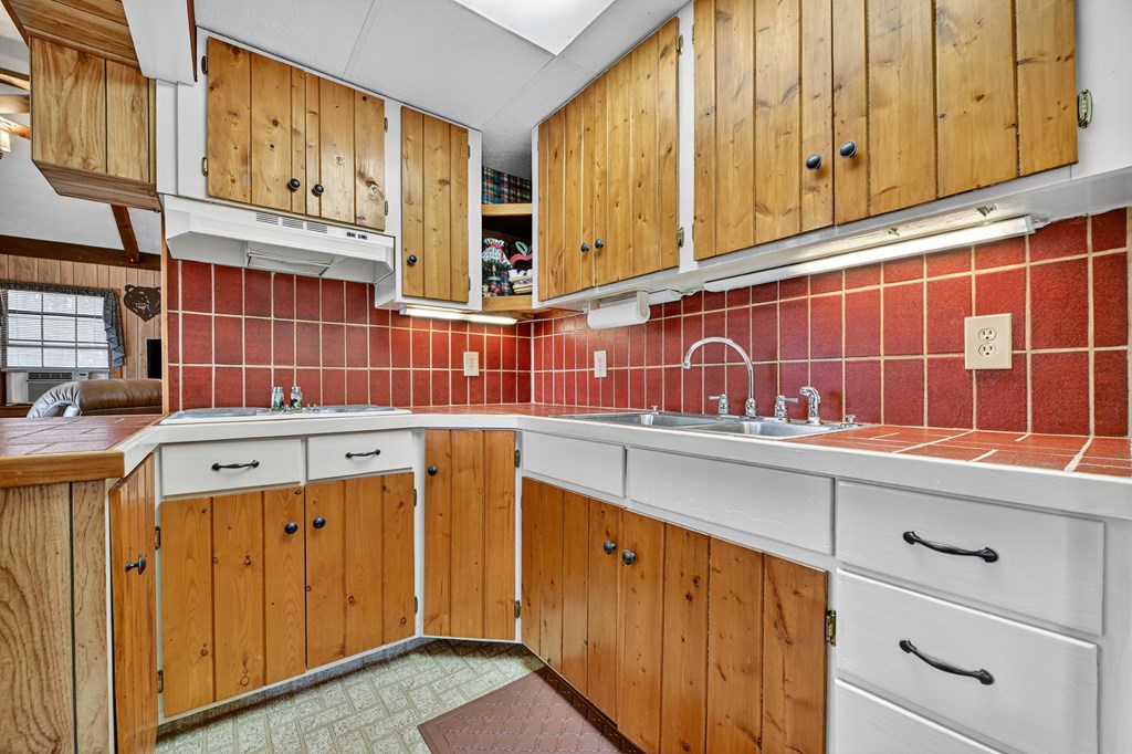 654 Stover Knob Trail Cherry Log, GA 30522 - Photo 11 of 44 a sink with cabinets and wooden floors