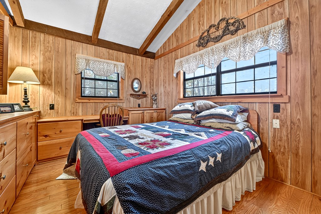 654 Stover Knob Trail Cherry Log, GA 30522 - Photo 15 of 44 a bedroom with a bed a dresser next to a window