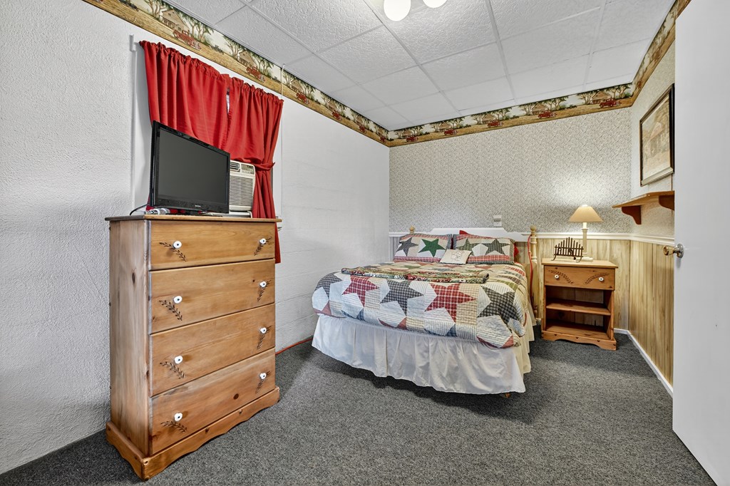 654 Stover Knob Trail Cherry Log, GA 30522 - Photo 21 of 44 a bedroom with a bed and a mirror on the dresser