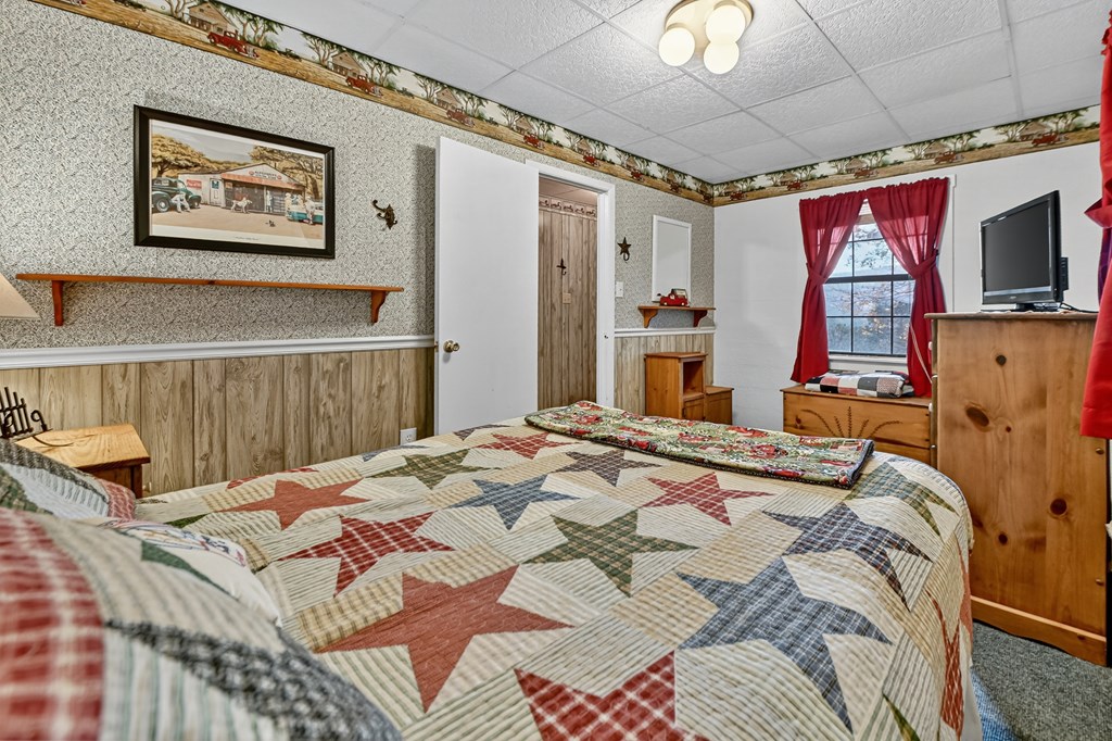 654 Stover Knob Trail Cherry Log, GA 30522 - Photo 22 of 44 a bedroom with a bed and a flat screen tv