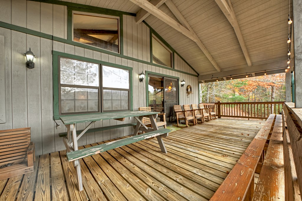 654 Stover Knob Trail Cherry Log, GA 30522 - Photo 29 of 44 a balcony with wooden floor table and chairs