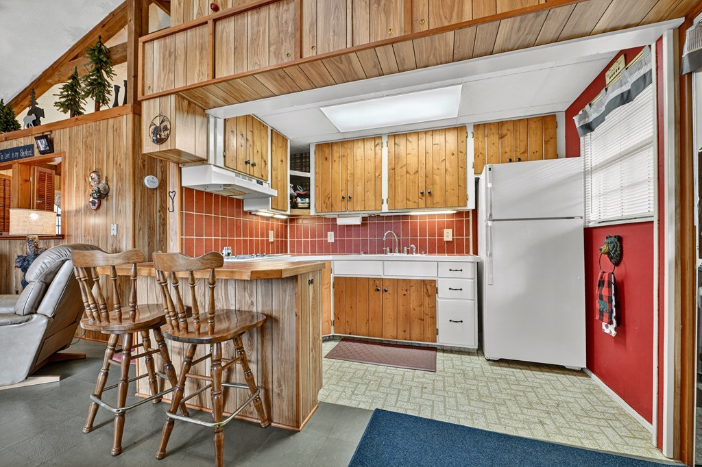 654 Stover Knob Trail Cherry Log, GA 30522 - Photo 9 of 44 a kitchen with stainless steel appliances granite countertop a refrigerator a stove and a wooden cabinets